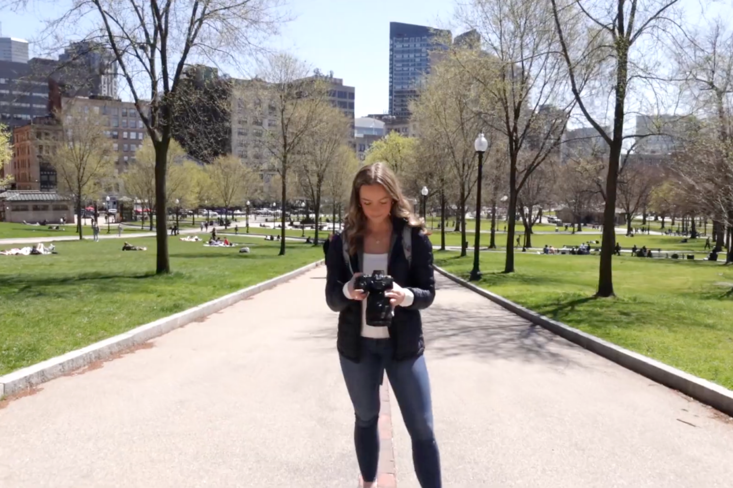 Student looking down at camera on Boston Common